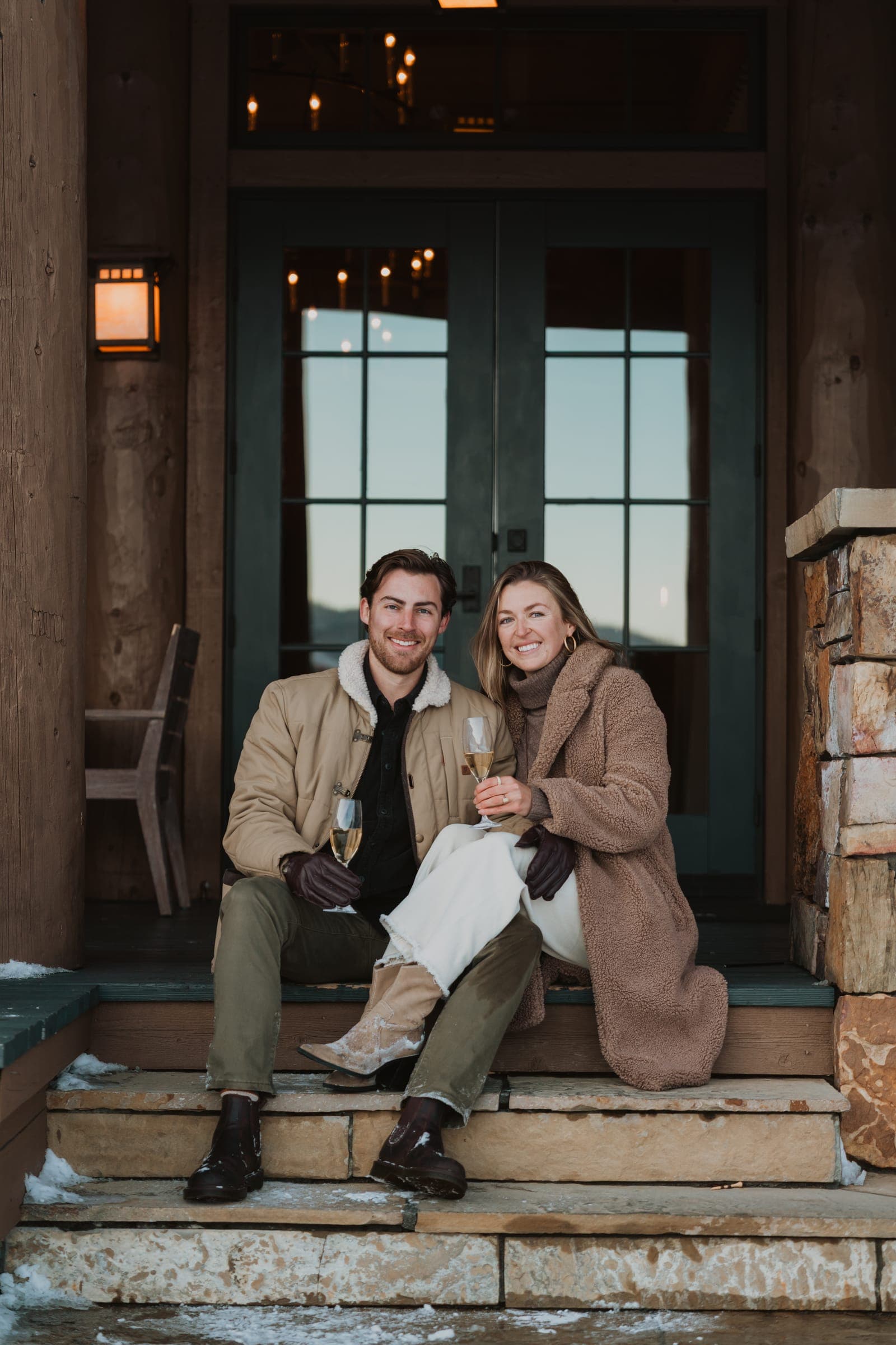Maggie and Noah toasting on the porch steps